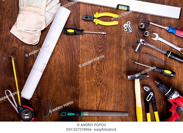 High Angle View Of Construction Tools With Blueprint On Wooden Desk