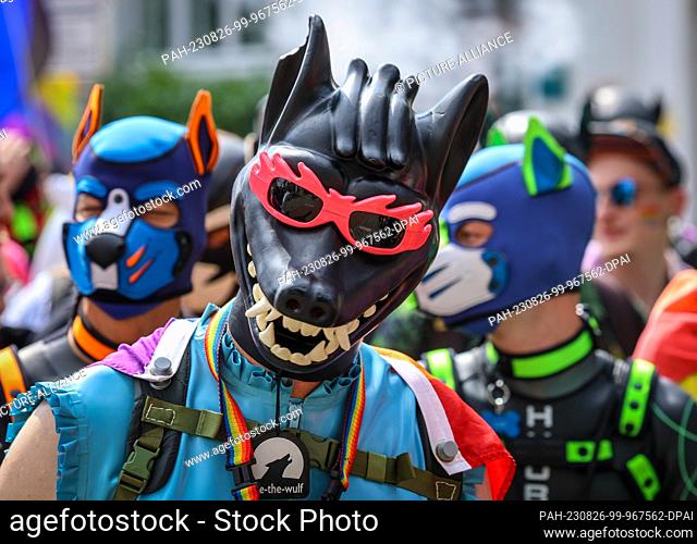 26 August 2023, Bremen: Participants of the Christopher Street Day (CSD) wear dog masks in Bremen. The police expected 10, 000 to 12