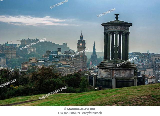 Calton Hill in Edinburgh, Scotland. Aerial view of the city with Castle and Clock Tower. Day, cloudy sky