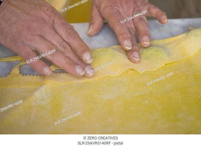 Hands forming pasta dough