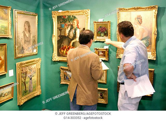 Impressionistic paintings (c.1890-1910) in antique dealer stall. Antique Show. Convention Center. Miami Beach. Florida. USA