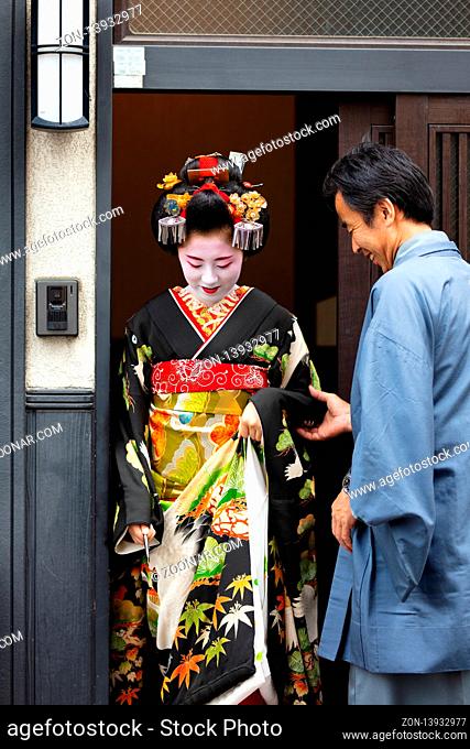 Kyoto, Japan - May 14 2019: Portrait of a young Maiko Geisha who is being led to houses of clientele by her guide in Gion district of Kyoto, Japan