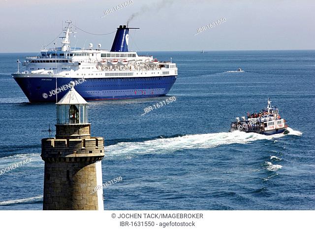 Cornet cruise ship at anchor, passenger ferry, off the pier with lighthouse at Castle Cornet, port fortress, entrance to the port of St