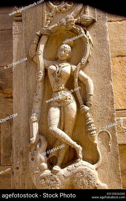 Statue of graceful lady in dancing pose on stone pillar at Rayara Gopura (Royal Tower) in Melukote, Mandya District, Karnataka, India, Asia