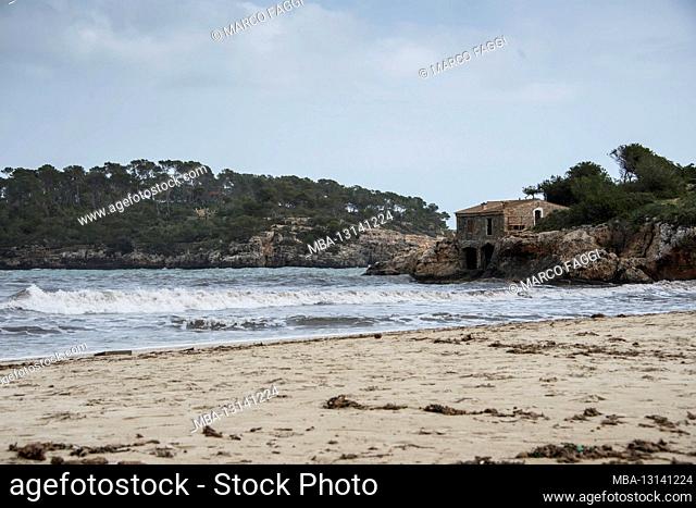 Sandy beach with house on the rocks, Mallorca
