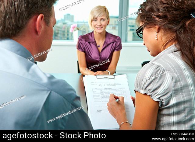 Conductors holding questionnaire form during the job interview, applicant's reults are excellent. Focus placed on sheet in front