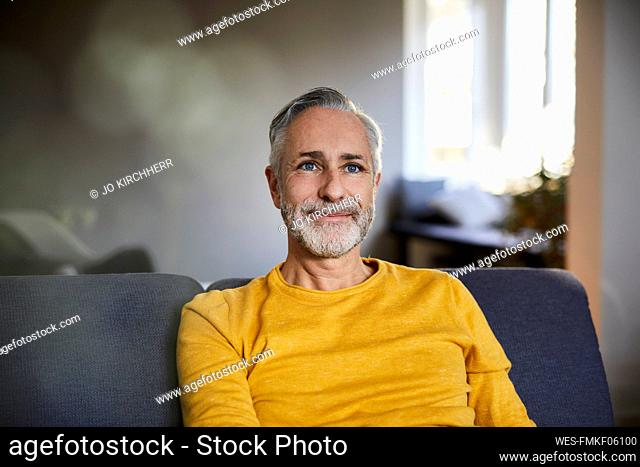 Portrait of confident mature man at home