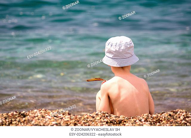 Little boy play near sea