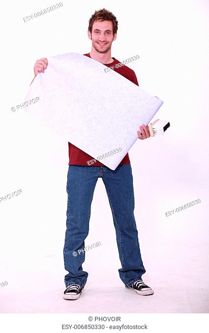 Handyman with wallpaper and glue brush