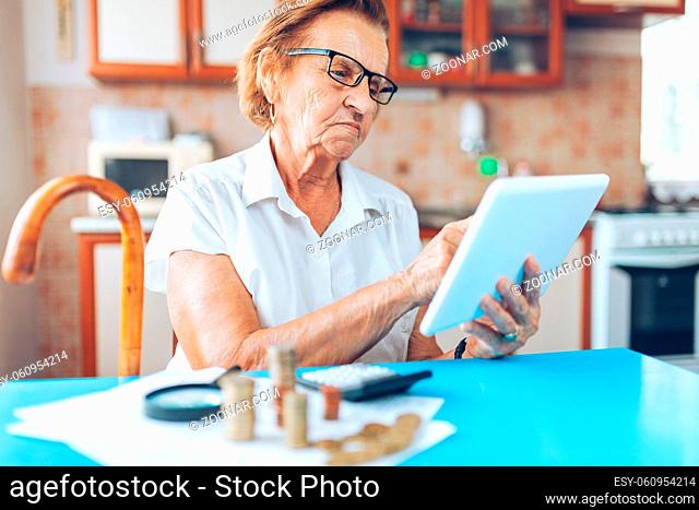 Senior woman at home checking her finances and invenstments