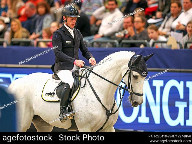 10 April 2022, Saxony, Leipzig: Marcus Ehning of Germany breaks off his run on Calanda in the final of the Longines Fei Jumping World Cup at the Leipzig Fair
