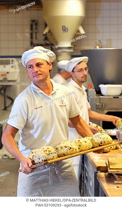 Employees of the Dresdner Backhaus GmbH bakery manufacturer, process Dresdner stollen cake, a German Christmas speciality, on the company's premises in Dresden