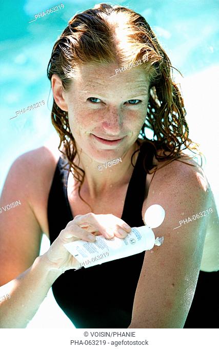 Woman applying sunblock