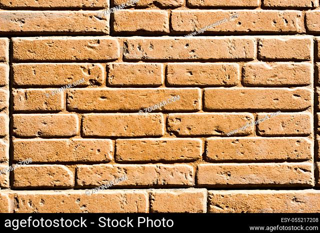 A tile imitating a brickwork of beige color. Textured background