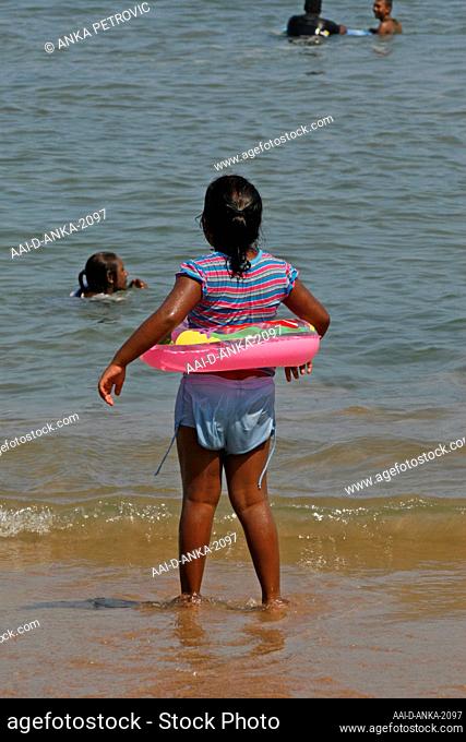 Child on the beach with floating ring, Umfolozi beach, KwaZulu Natal, South Africa