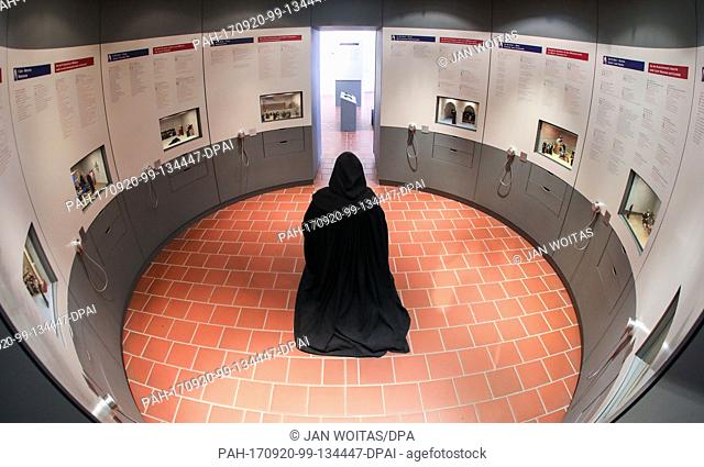 A monk puppet with robe kneels in an exhibition about the life of the monks in the Memleben monastery in Memleben, Germany, 20 September 2017