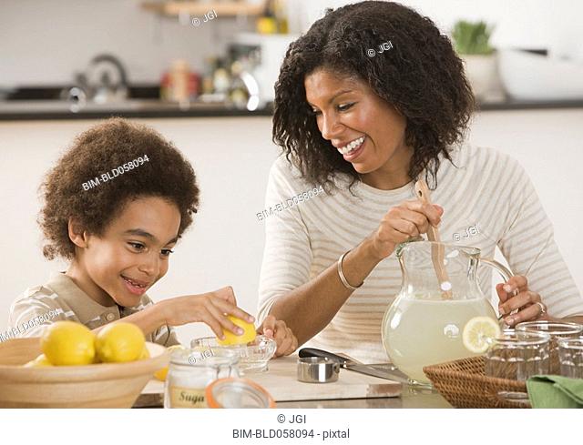 African mother and son making lemonade