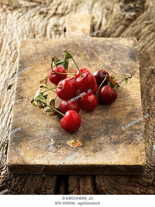 Morello cherries on old chopping board