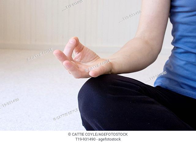 Woman doing yoga in a studio  Pose: 'Jnana mudra'  MR