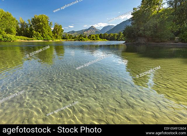 Mountains in the background of the reflective river of Wenatchee in Leavenworth Washington. Beautiful views of the small town of Leavenworth