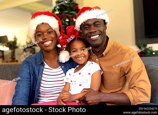 Happy african american family spending time together siting on the sofa