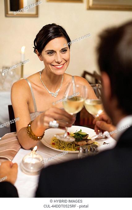 Couple toasting each other in restaurant