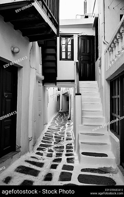 Perspective of narrow street in Mykonos (Chora) town, Greece. Black and white rchitectural photography