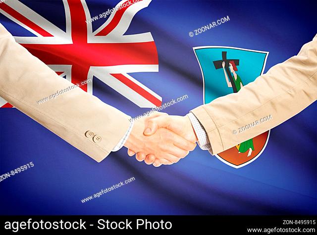 Businessmen shaking hands with flag on background - Montserrat