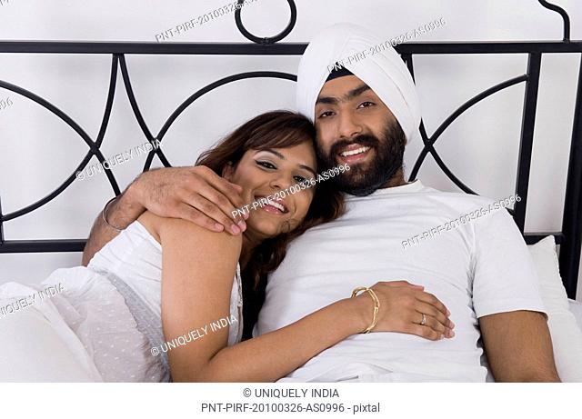 Sikh couple lying on the bed