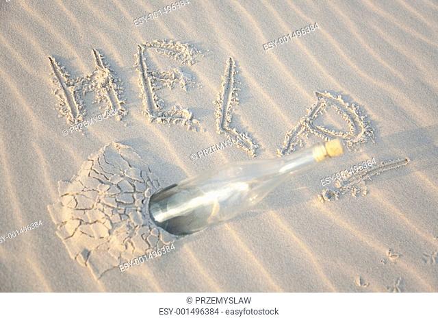 A clear glass bottle washed up on the beach