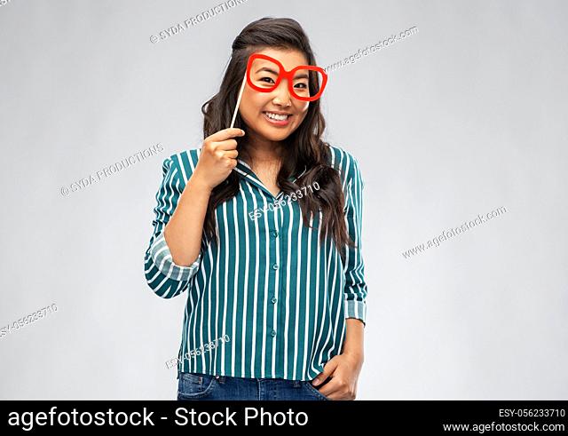 happy asian woman with big party glasses
