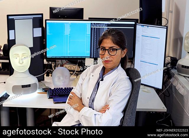 Portrait of female engineer at work station