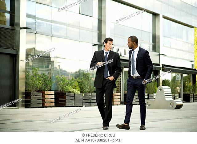 Business colleagues walking and talking together