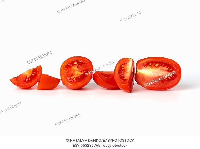 ripe red whole tomatoes and pieces on a white background, autumn harvest for salad and cooking
