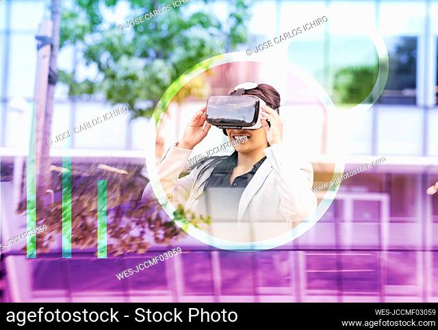 Businesswoman smiling while using virtual reality headset