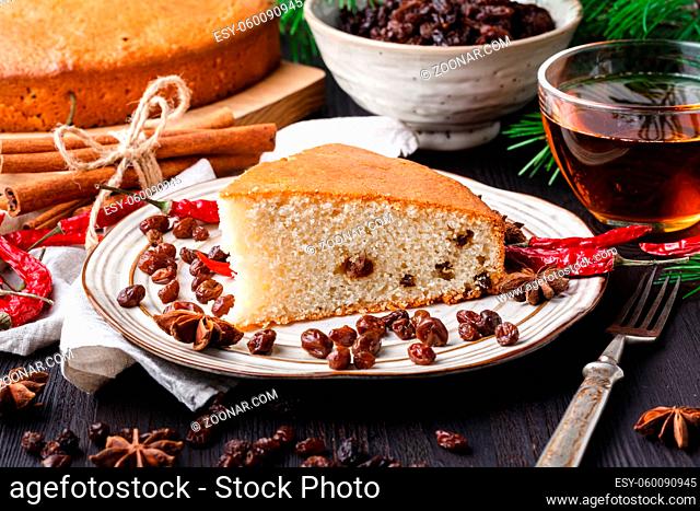 Beautiful delicious homemade Christmas dried fruit cake on wooden table with decorating items for celebrating festive season