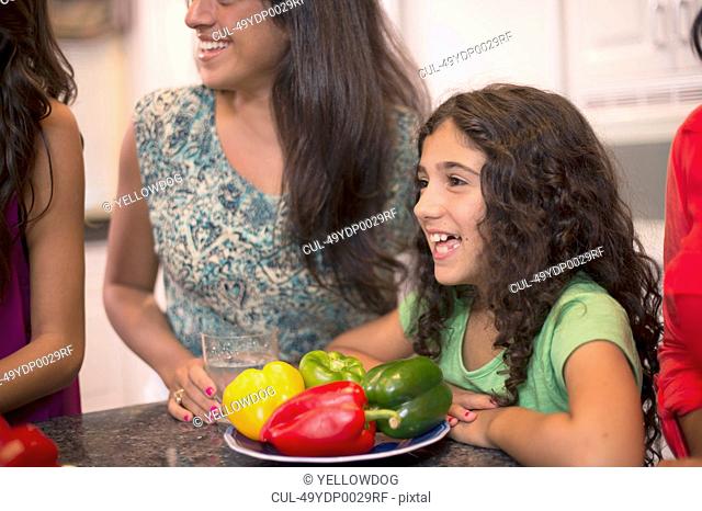 Smiling girl with family in kitchen