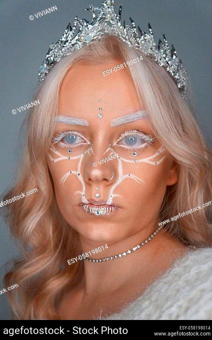 young blond woman with glitter makeup and crown