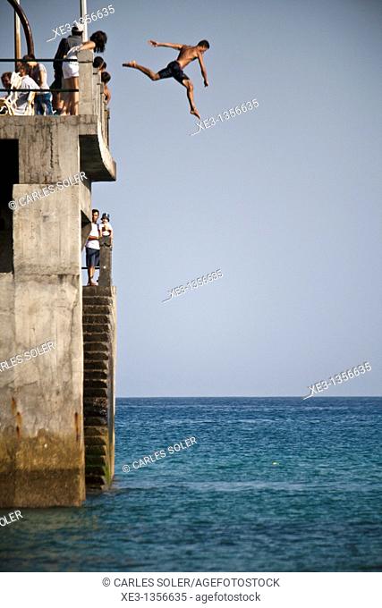 Man jumping from the dock, Porto santo, Madeira
