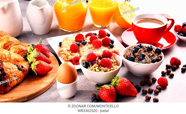Breakfast served with coffee, orange juice, croissants, egg, cereals and fruits. Balanced diet