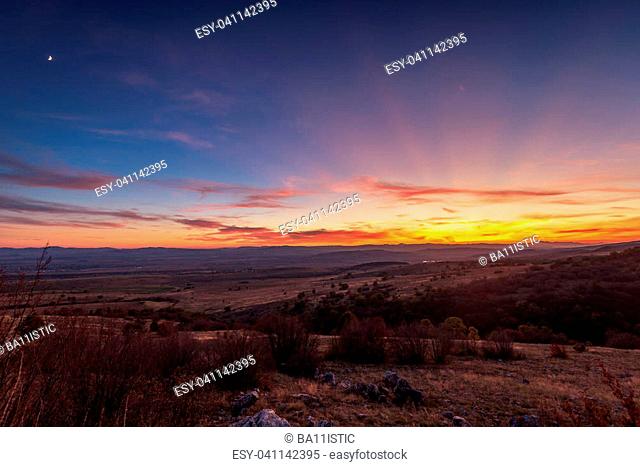Mountain autumn sunset panoramic landscape with colorful forest