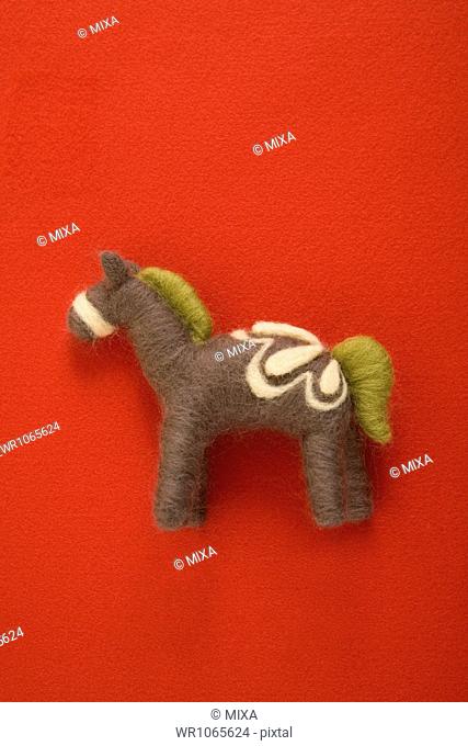 Felt Toy Horse on Red Paper