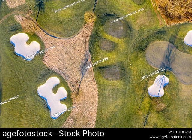 Germany, Bavaria, Wolfratshausen, Drone view of countryside golf course at dawn