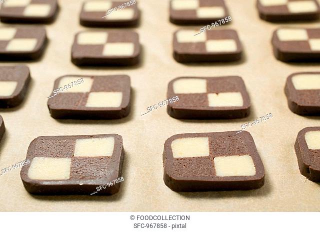 Biscuits cut from chocolate and plain dough in rows