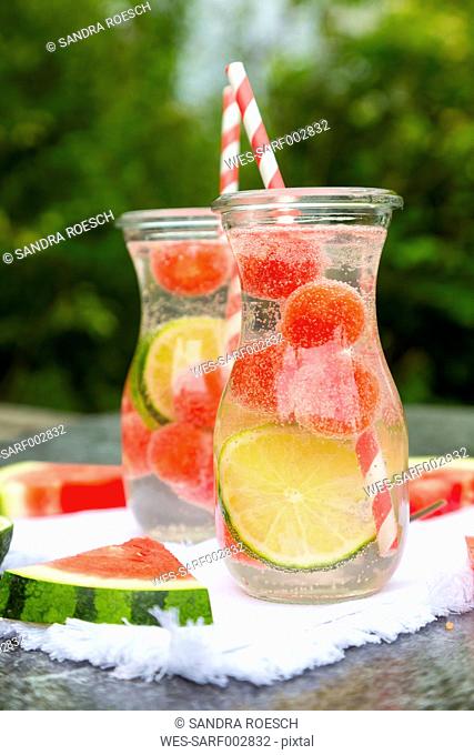Two carafes of infused water with watermelon and lime