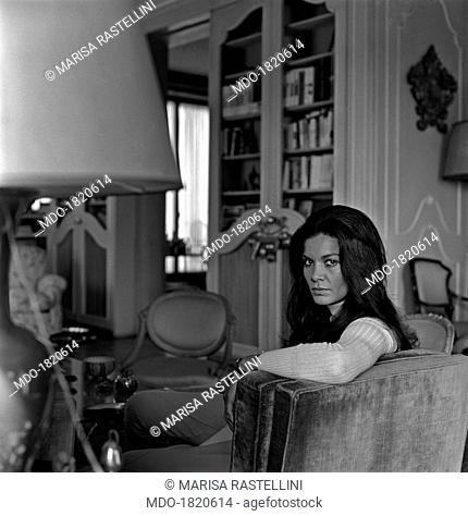 Brazilian actress Florinda Bolkan, Florinda Soares Bulcão's stage name, looks at the camera sitting on the sofa in the living room of her house; after having...