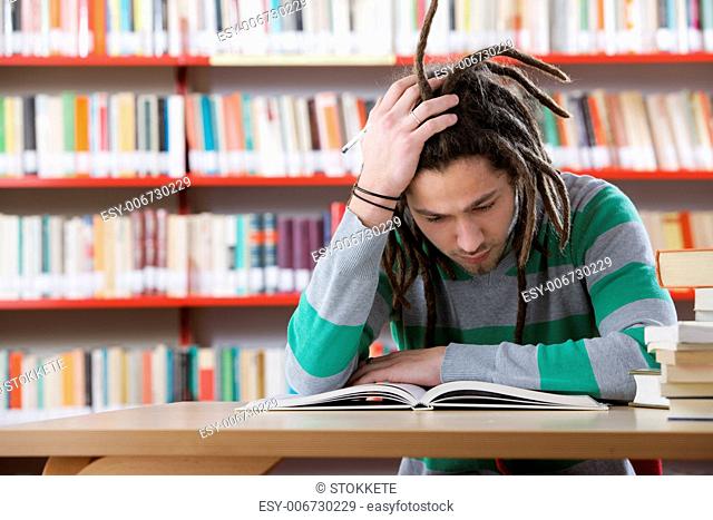 Student sitting in the library and working hardly