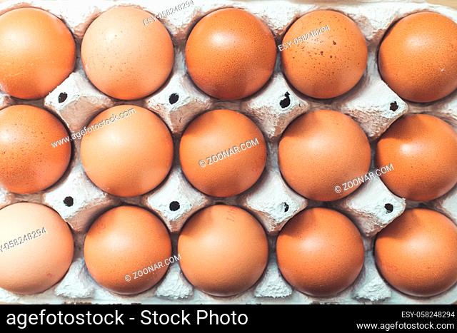 Top view of chicken eggs in a basket