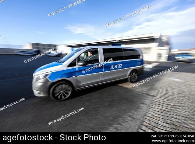 11 December 2023, Saxony, Dresden: A fully electric prisoner transporter drives through the courtyard of the Dresden - Hammerweg prison during the handover of...