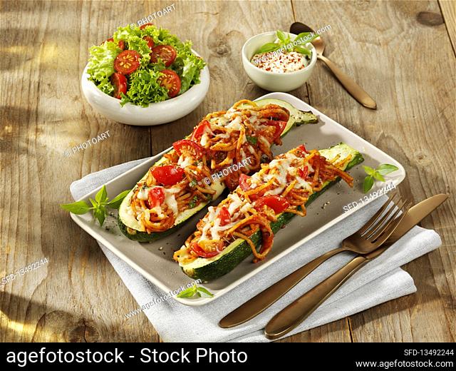 Stuffed zucchini with spaghetti, tomatoes, and cheese